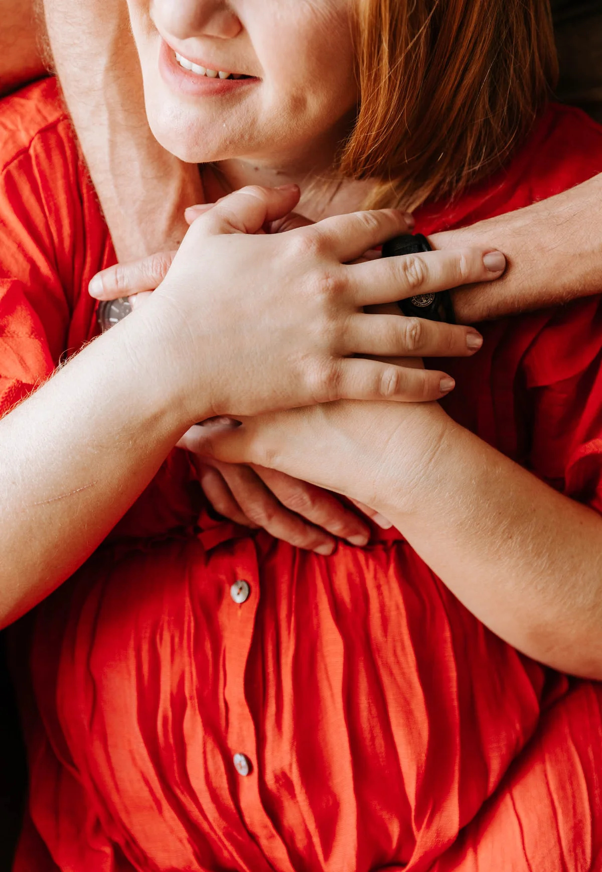 Close up of a couple's hands embraced together during a maternity session