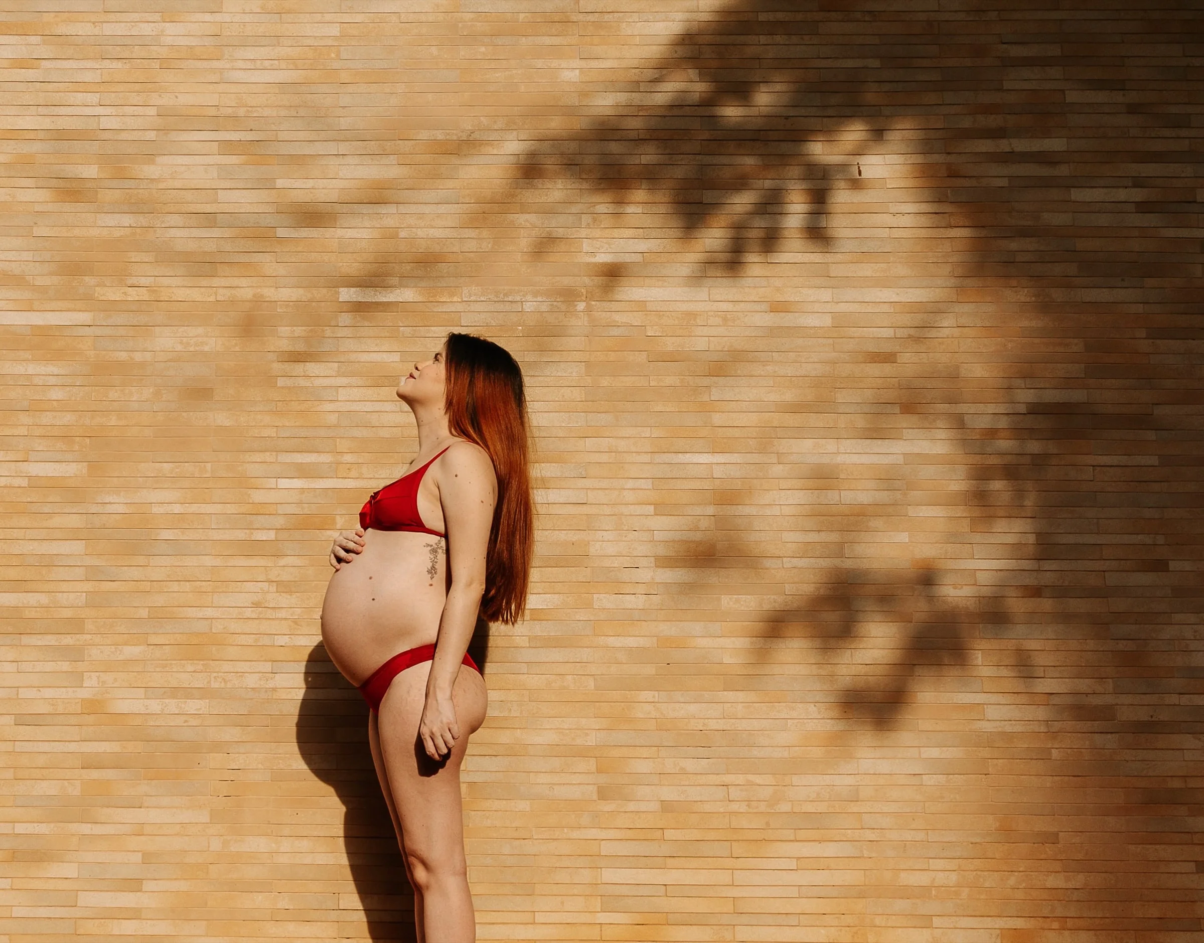 Expecting mother in warm light and soft shadows